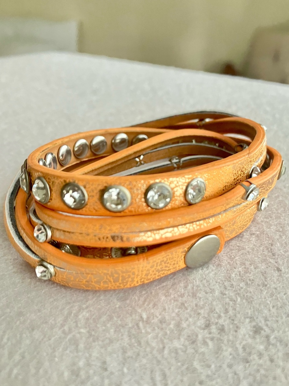 Orange metallic wrap bracelet with crystal rhinestone studs